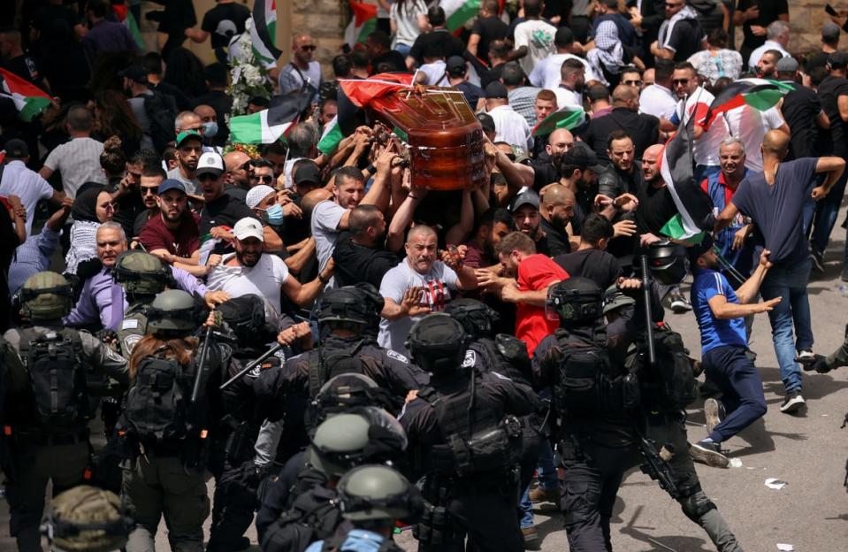 <div class="inline-image__caption"><p>Family and friends carry the coffin of Al Jazeera reporter Shireen Abu Akleh, who was killed during an Israeli raid in Jenin in the West Bank, as clashes erupted with Israeli security forces during her funeral in Jerusalem on May 13.</p></div> <div class="inline-image__credit">Ammar Awad/Reuters</div>
