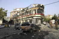 Afghan security personnel stand guard following an attack in Kabul, Afghanistan, Wednesday, Aug. 4, 2021. A powerful explosion rocked an upscale neighborhood of Afghanistan's capital Tuesday in an attack that apparently targeted the country's acting defense minister. (AP Photo/Rahmat Gul)