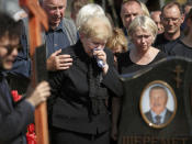 <p>Mother of killed journalist Pavel Sheremet and his partner Olena Prytula, right, cry during his funeral at a cemetery in Minsk, Belarus, Saturday, July 23, 2016. Prominent journalist Pavel Sheremet died Wednesday, when his car was bombed in Ukraine, and is being buried in his hometown of Minsk, Belarus. (Photo: AP)</p>