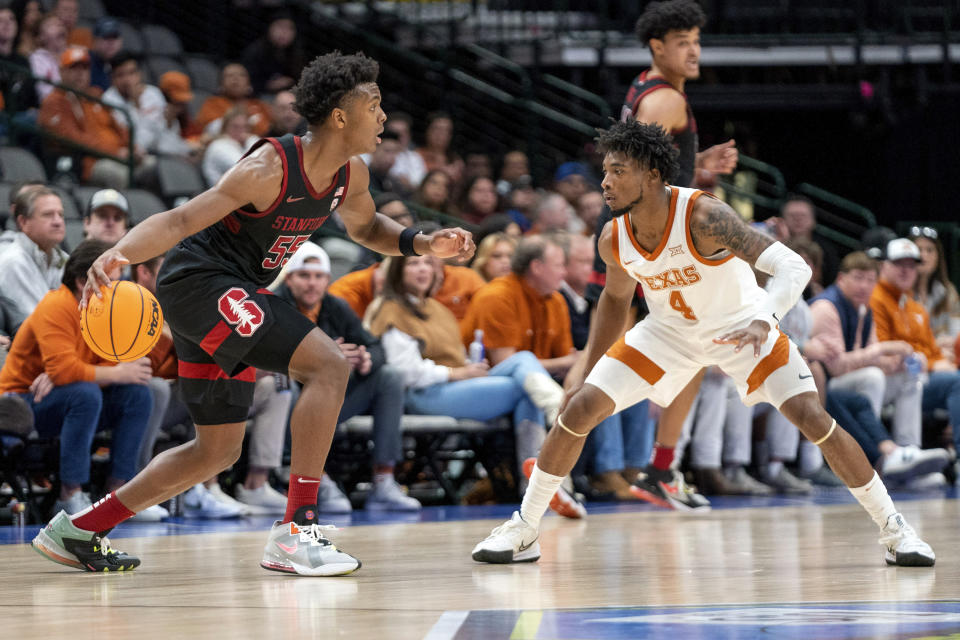 Stanford guard Harrison Ingram (55) drives against Texas guard Tyrese Hunter (4) during the first half of an NCAA college basketball game, Sunday, Dec. 18, 2022, in Dallas. (AP Photo/Jeffrey McWhorter)