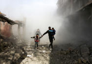 <p>Syrian civlians flee from reported regime air strikes in the rebel-held town of Jisreen, in the besieged Eastern Ghouta region on the outskirts of the capital Damascus, on Feb. 8, 2018. (Photo: Abdulmonan Eassa/AFP/Getty Images) </p>