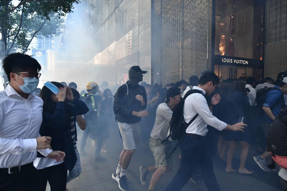 People react after tear gas was fired by police during a protest in Hong Kong on November 11, 2019. | ANTHONY WALLACE—AFP via Getty Images
