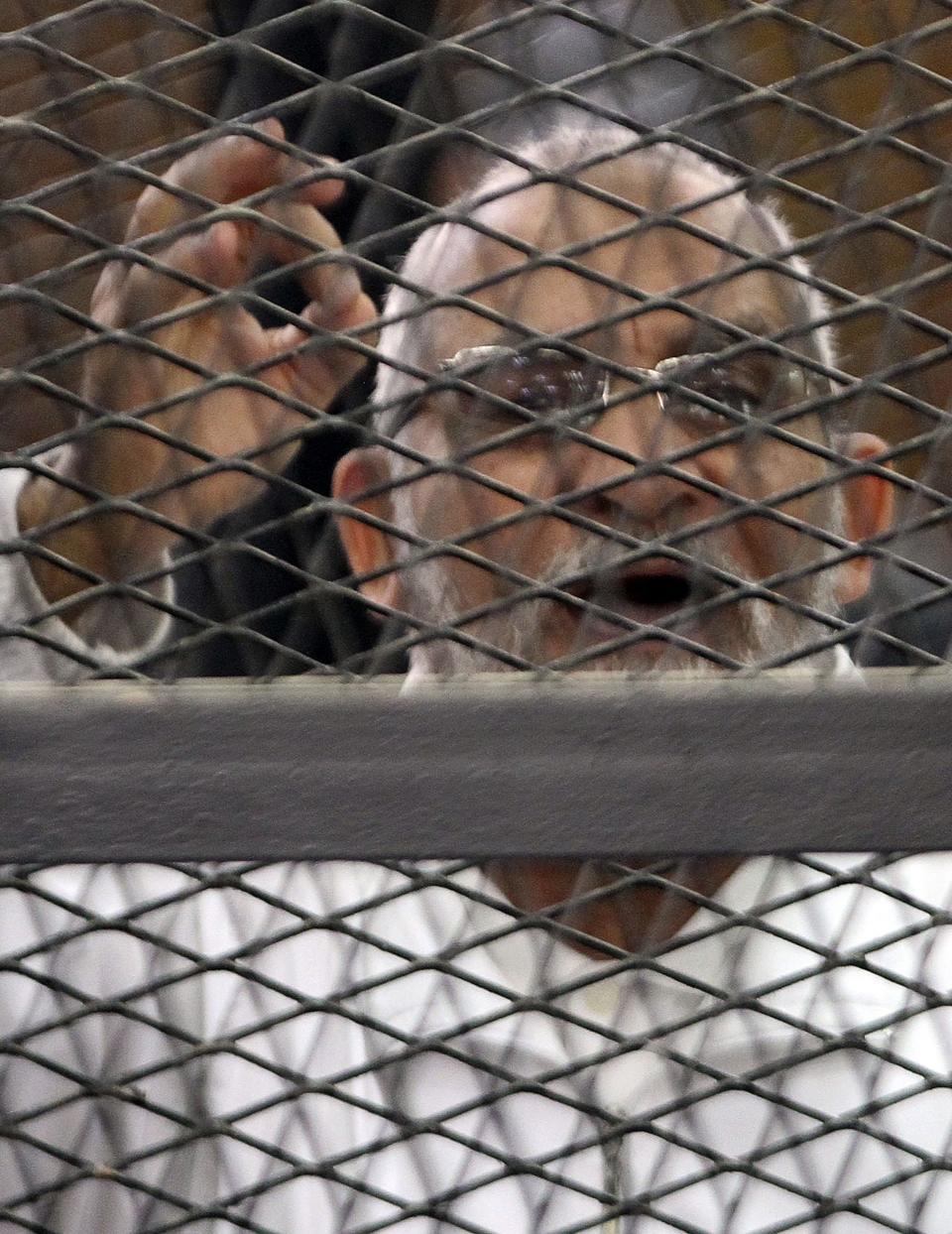 Muslim Brotherhood leader Mohammed Badie shouts slogans during his trial in Cairo