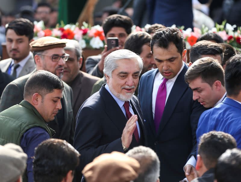 Afghanistan's former Chief Executive Officer Abdullah Abdullah is surrounded by supporters as he arrives for his swearing-in ceremony as Afghanistan's president, in Kabul