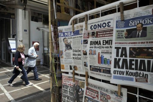 Newspapers featuring the political impasse are displayed at a kiosk in Athens May 11. Greece's president was set Saturday to call last-ditch talks in a bid to forge an emergency unity government and avoid fresh elections, after the main parties failed to form a working coalition