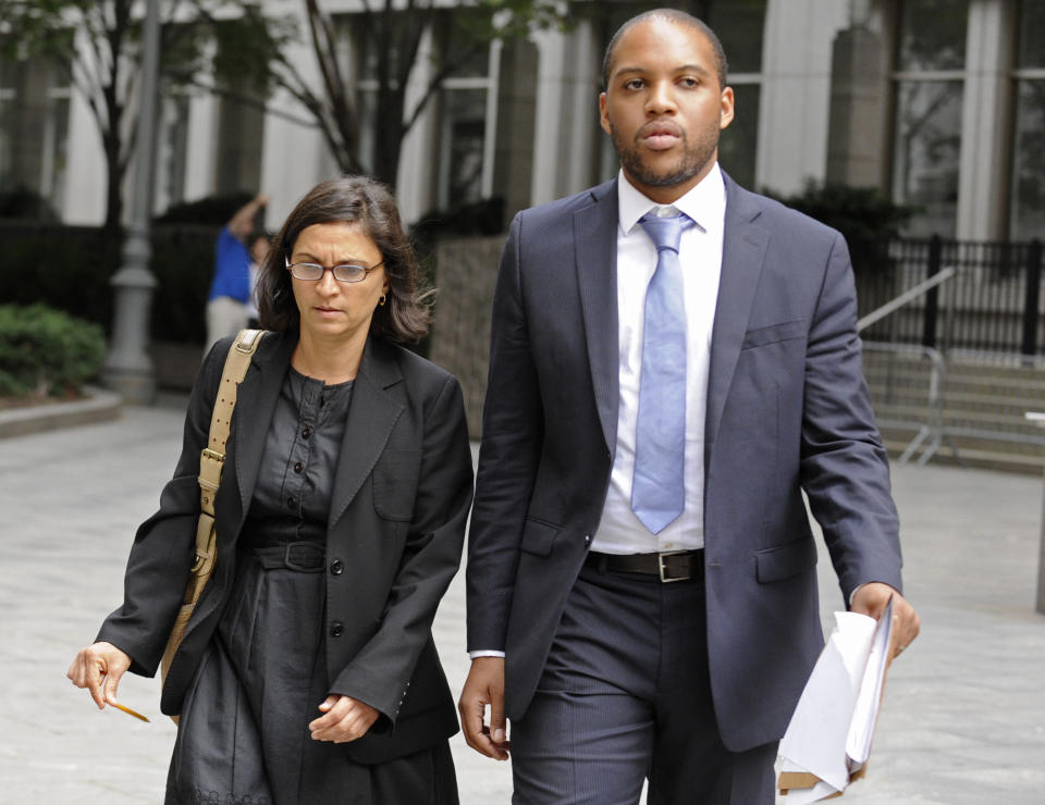 FILE - In this Oct. 6, 2012, file photo, federal defense attorneys Sabrina Shroff, left, and Jerrod Thompson Hicks exit Manhattan federal court, in New York where they were representing Mustafa Kamel Mustafa, charged with conspiring to set up a terrorist training camp in Oregon and of helping abduct 16 hostages, two of them American tourists, in Yemen in 1998. It can be an uncomfortable life for any defense attorney representing unpopular clients, but lawyers who agree to speak on behalf of people accused of plotting to kill Americans in terrorist attacks walk difficult road. But representing every client, regardless of the crime, is the “very essence of being a federal defender," said Shroff, an assistant federal defender. (AP Photo/ Louis Lanzano, File)
