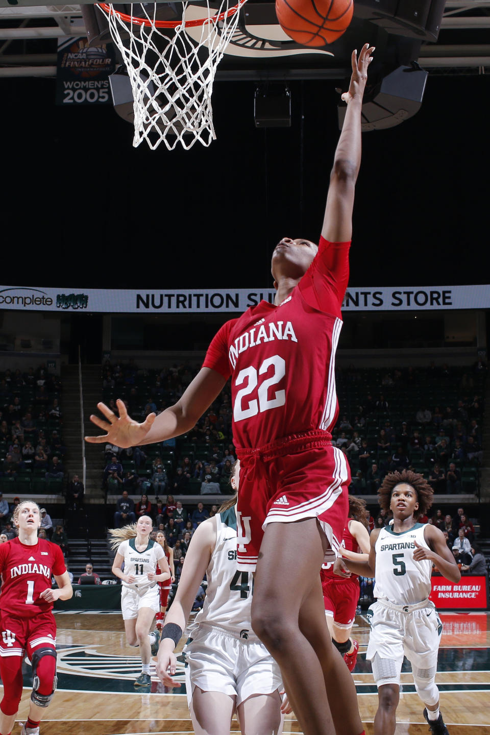 Indiana's Chloe Moore-McNeil (22) gets a fast-break layup ahead of Michigan State's Julia Ayrault, center, and Kamaria McDaniel (5) during the second half of an NCAA college basketball game on Thursday, Dec. 29, 2022, in East Lansing, Mich. (AP Photo/Al Goldis)