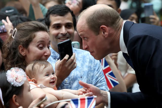 <p>Chris Jackson/Getty</p> Prince William meets 8-month-old Albane Costa at Changi Airport on November 5.