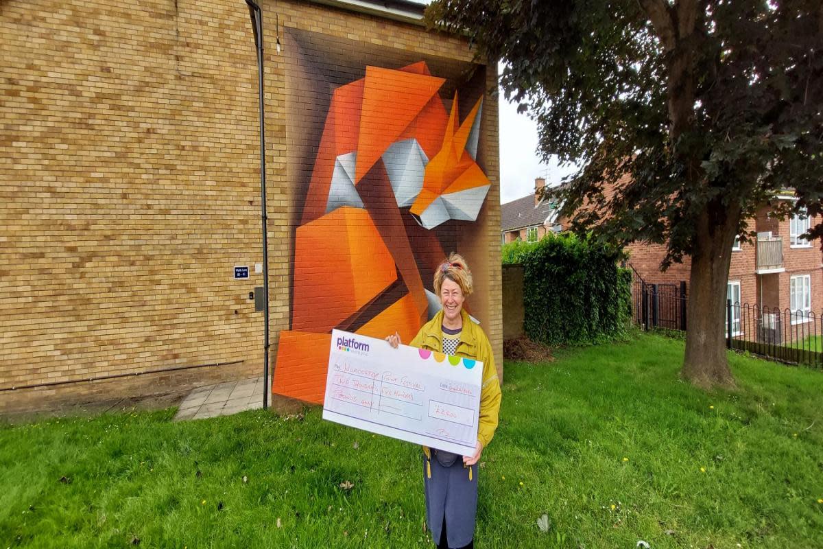 Kate Cox, Worcester Paint Festival director and producer, with the giant cheque <i>(Image: Platform)</i>