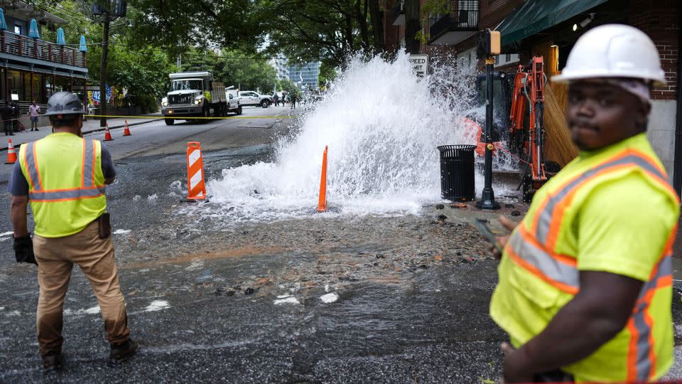 Workers in Atlanta respond to a broken water transmission line Saturday. - Mike Stewart/AP