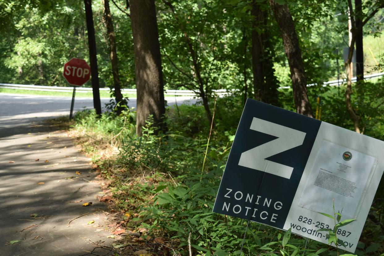 A zoning notice sits outside the Goodman Road and Riverside Drive property in Woodfin where 300 new units have been proposed by developers.