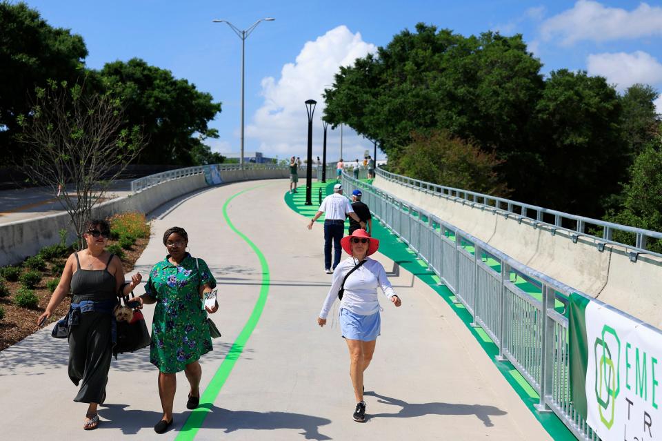 City Hispanic outreach coordinator Yaya Cardona, left, walks a part of the Emerald Trail's LaVilla Link with city sustainability manager Ashantae Green after a ceremony Monday opening that leg of the trail.