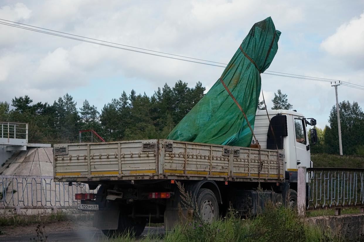 A truck carries a part of a private jet crashed near the village of Kuzhenkino (AP)