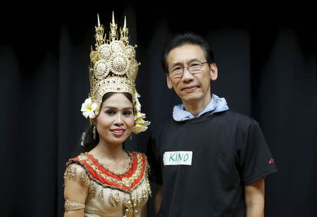 Ky Tu Duong (R), a former Vietnam refugee who now goes by his Japanese name Hitoshi Kino, and Cheth Chan Chrisna, a former Cambodian refugee who now goes by her married name Chrisna Ito, pose for pictures during Asia Sports Festa in Yokohama, south of Tokyo, Japan, October 25, 2015. REUTERS/Yuya Shino/Files