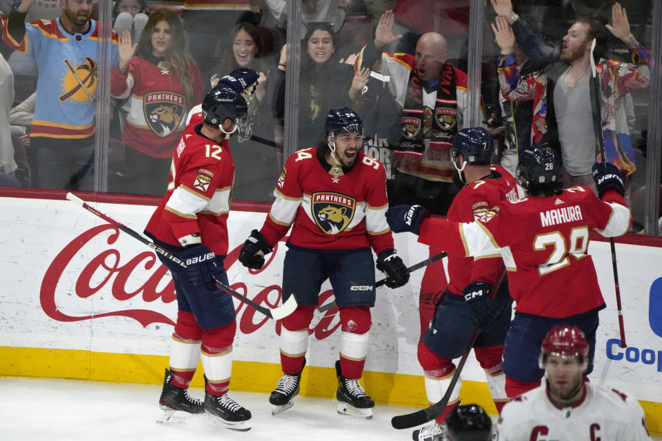 Florida Panthers left wing Ryan Lomberg, second from left, reacts after scoring during the third period of an NHL hockey game against the Carolina Hurricanes, Thursday, April 13, 2023, in Sunrise, Fla. (AP Photo/Lynne Sladky)