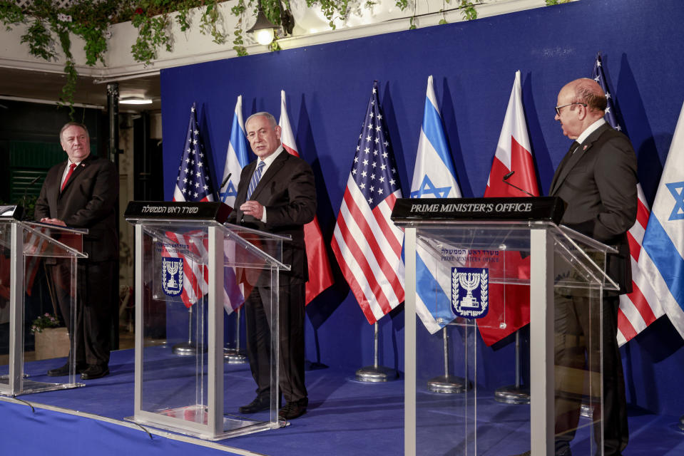 U.S. Secretary of State Mike Pompeo, left, and Bahrain's Foreign Minister Abdullatif bin Rashid Alzayani, right, listen as Israeli Prime Minister Benjamin Netanyahu speaks during a joint press conference after their trilateral meeting in Jerusalem on Wednesday, Nov. 18, 2020. (Menahem Kahana/Pool via AP)