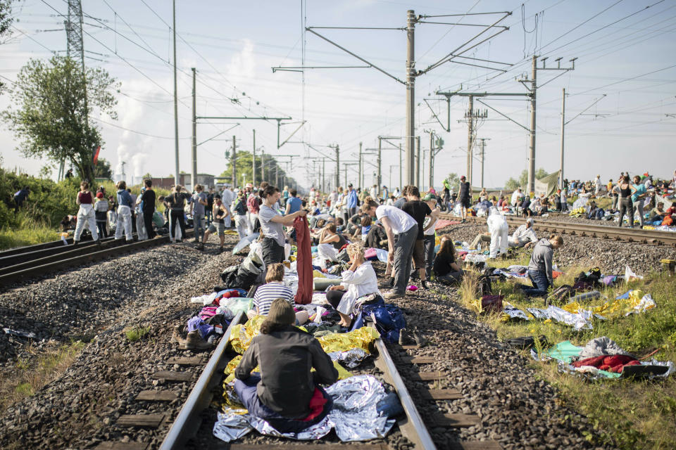 Numerous environmental activists block the tracks of the coal transport railway in Rommerskirchen, Germany, Saturday, June 22, 2019. The protests for more climate protection in the Rhineland continue. Many participants are expected for protests and actions at the Garzweiler opencast mine. Photo by: (Marcel Kusch/dpa via AP)