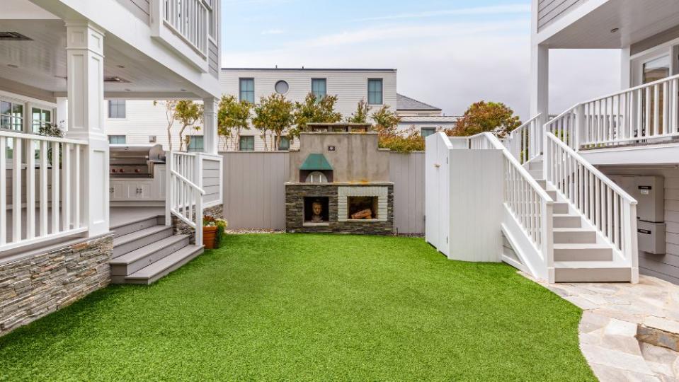 A grassy courtyard sits between the main house and guest house.