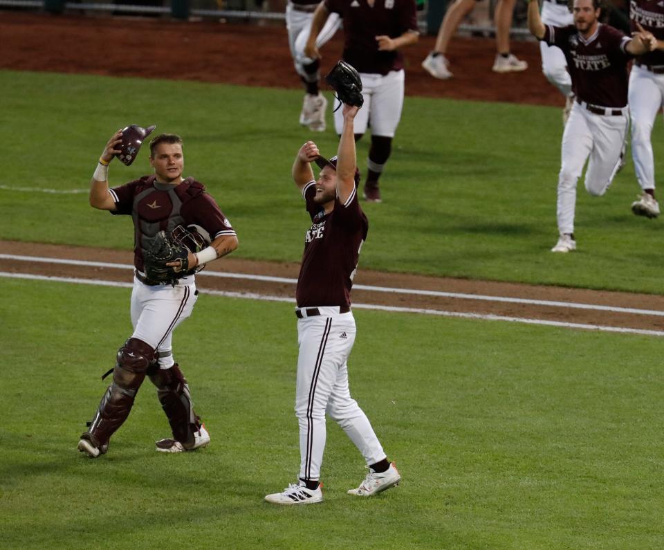 Jun 30, 2021; Omaha, Nebraska, USA;  Mississippi State Bulldogs catcher Logan Tanner (19) and pitcher Landon Sims (23) celebrate after defeating the Vanderbilt Commodores at TD Ameritrade Park. Mandatory Credit: Bruce Thorson-USA TODAY Sports