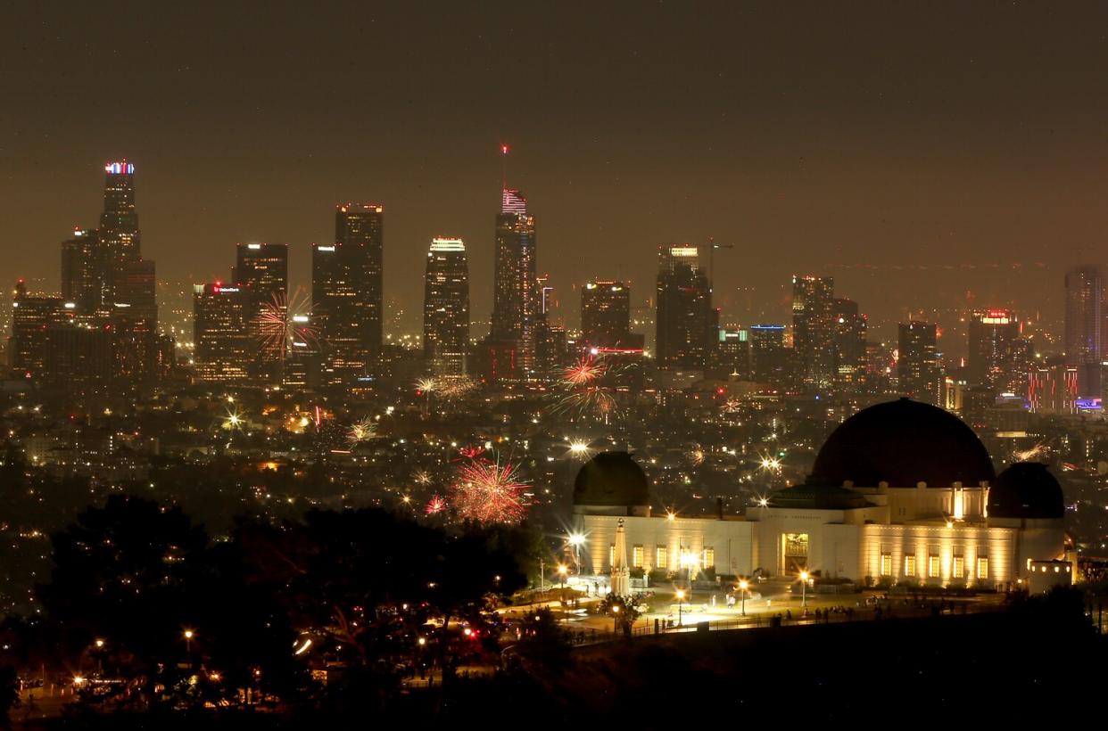 Illegal fireworks explode over downtown Los Angeles on the Fourth of July.