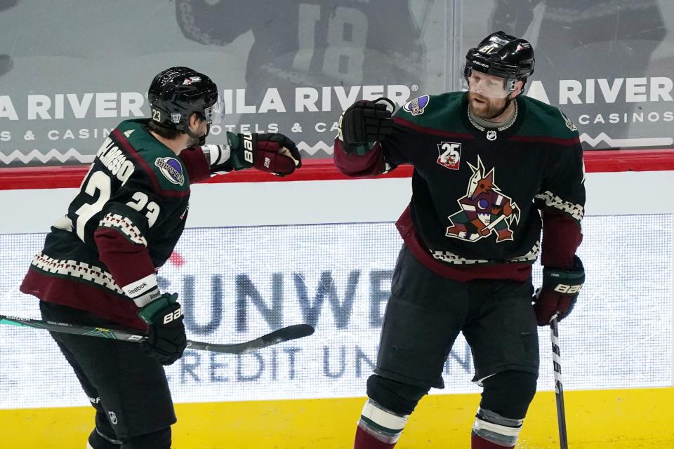 Arizona Coyotes right wing Phil Kessel, right, celebrates his goal against the San Jose Sharks with teammate Oliver Ekman-Larsson (23) during the first period of an NHL hockey game Saturday, Jan. 16, 2021, in Glendale, Ariz. (AP Photo/Ross D. Franklin)