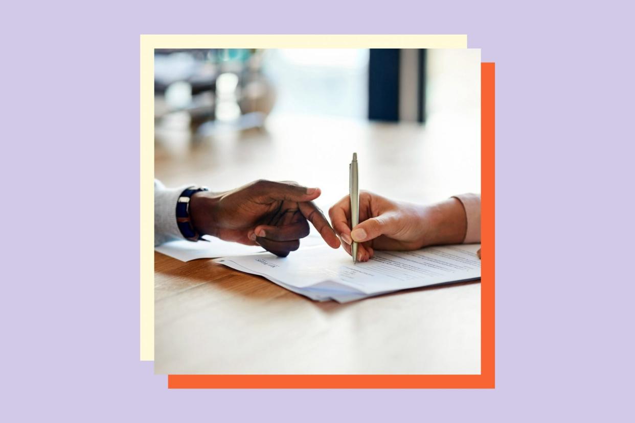 An image of people signing a document.