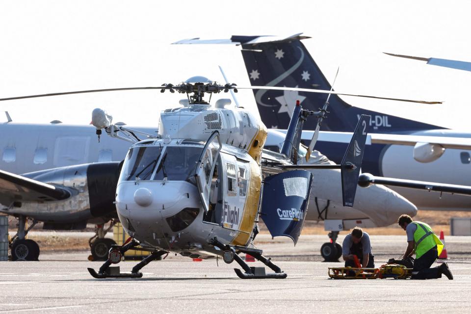 A Care Flight helicopter is seen on the tarmac of the Darwin International Airport in Darwin on August 27, 2023, as rescue work is in progress to transport those injured in the US Osprey military aircraft crash at a remote island north of Australia's mainland.