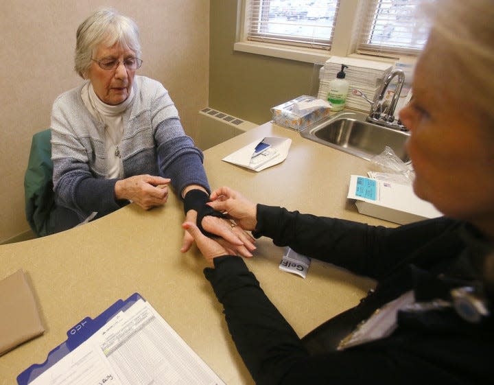 Anna Marie Wilton, 83 of Akron gets fitted for a brace for carpal tunnel.