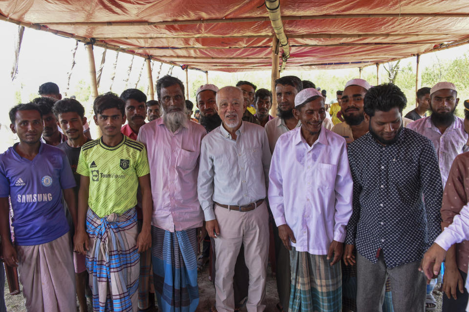 Japanese philanthropic group Nippon Foundation's Chairman Sasakawa Yohei, center, poses for photographs with Rohingya refugees during a visit to Bhasan Char island in the Bay of Bengal, in Bangladesh, Saturday, April 6, 2024. Japan's Nippon Foundation will spend $2 million to help move tens of thousands more Rohingya refugees to the remote island in Bangladesh and provide them with skills training, Sasakawa said. (Nippon Foundation via AP)