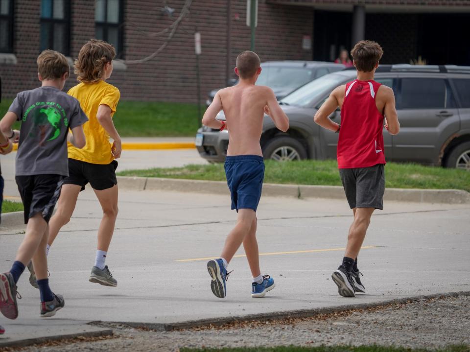 ADM runner Brycen Timmer, second from the right, runs during cross country practice in Adel on Sept. 16.