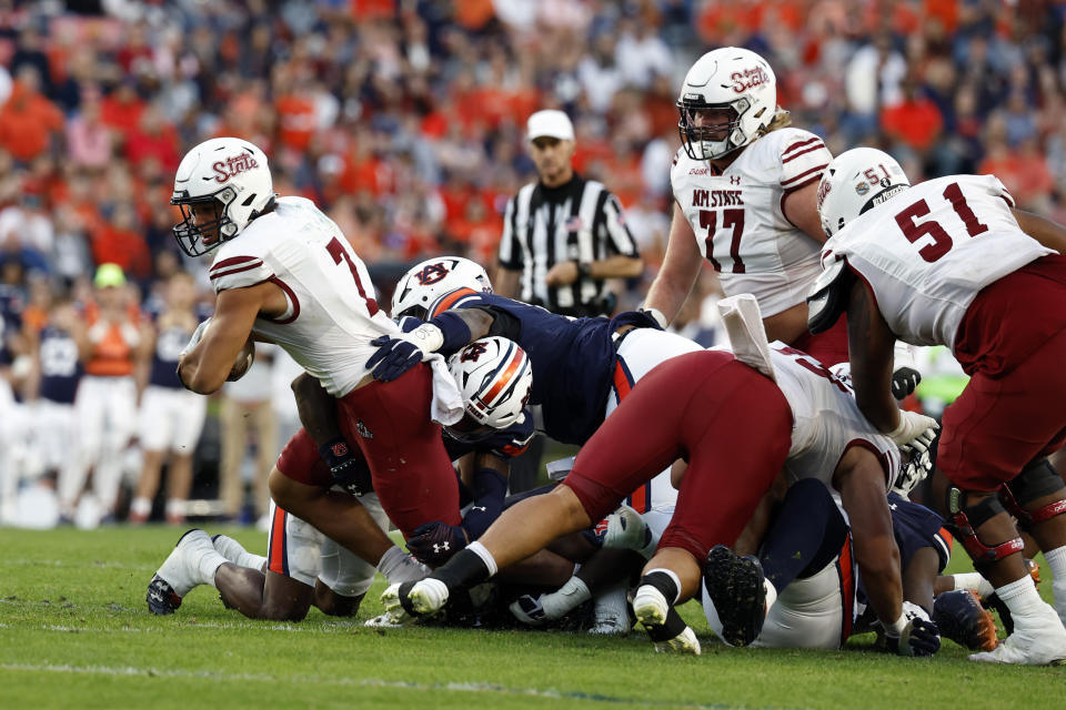 New Mexico State quarterback Eli Stowers (7) carries the ball during the first half of an NCAA college football game against Auburn Saturday, Nov. 18, 2023, in Auburn, Ala. (AP Photo/Butch Dill)