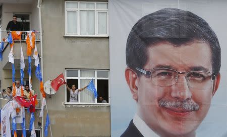 Supporters of Turkey's Prime Minister Ahmet Davutoglu listen to his speech from their houses during an election rally for Turkey's June 7 parliamentary elections in Istanbul, Turkey, June 2, 2015. REUTERS/Murad Sezer