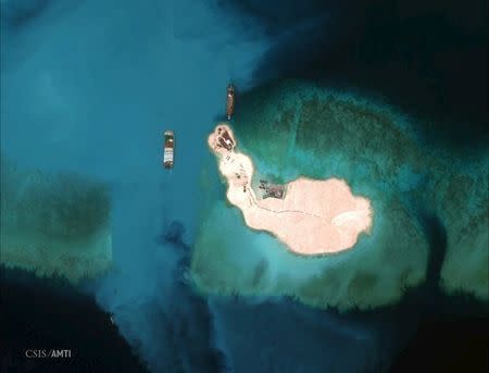 At the southernmost feature, cargo is unloaded onto the shore of Mischief Reef, located 216 km (135 miles) west of the Philippine island of Palawan, in this Center for Strategic and International Studies (CSIS) Asia Maritime Transparency Initiative satellite image taken on March 16, 2015 and released to Reuters on April 9, 2015. REUTERS/CSIS's Asia Maritime Transparency Initiative/Digital Globe/Handout