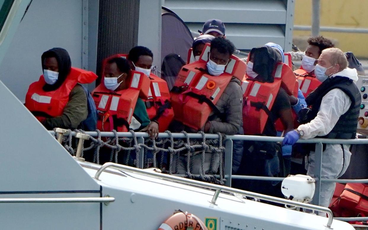 Border Force officials bring a group of people thought to be migrants into Dover on Monday -  Gareth Fuller/PA