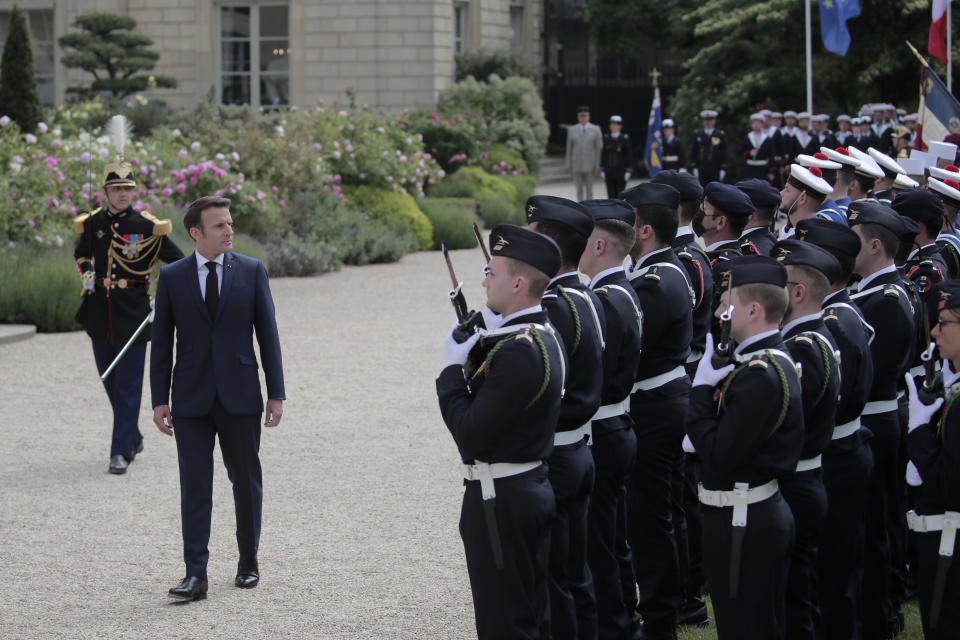 French President Emmanuel Macron reviews military troops during the ceremony of his inauguration for a second term at the Elysee palace, in Paris, France, Saturday, May 7, 2022. Macron was reelected for five years on April 24 in an election runoff that saw him won over far-right rival Marine Le Pen. (AP Photo/Lewis Joly)