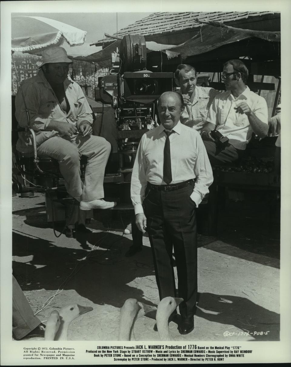 Jack Warner, the spotlight-grabbing head of production at Warner Bros., is shown on the set of "1776" in 1972. By then, Warner was no longer with the studio that bore his family name.