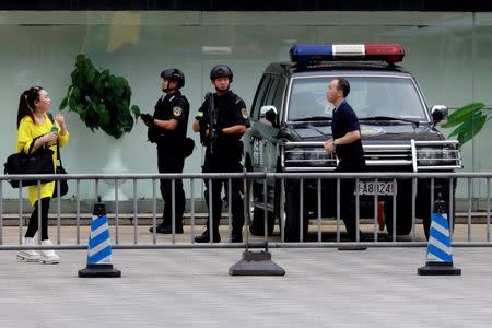 Heavily armed police officers stand guard near the venue where the G20 Finance Ministers and Central Bank Governors Meeting will be held over the weekend in Chengdu in Southwestern China's Sichuan province, July 22, 2016. REUTERS/Ng Han Guan/Pool