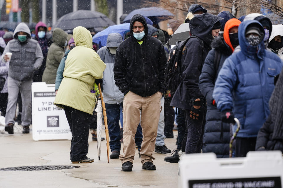 FILE - In this Feb. 19, 2021, file photo, people wait in line at a 24-hour, walk-up COVID-19 vaccination clinic hosted by the Black Doctors COVID-19 Consortium at Temple University's Liacouras Center in Philadelphia. States are scrambling to catch up on coronavirus vaccinations after bad weather last week led to clinic closures and shipment backlogs. (AP Photo/Matt Rourke, File)