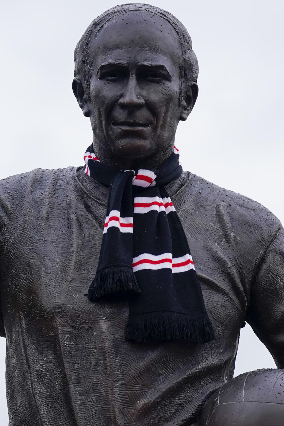 A statue of Sir Bobby Charlton is seen prior the Champions League group A soccer match between Manchester United and Copenhagen at the Old Trafford stadium in Manchester, England, Tuesday, Oct. 24, 2023. Manchester United and England soccer great Bobby Charlton has died at the age of 86. He was an English soccer icon who survived a plane crash that decimated a United team destined for greatness to become the heartbeat of his country's 1966 World Cup-winning team. (AP Photo/Dave Thompson)