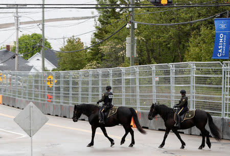 Canadian mounted police patrol next to a security fence built around the red zone security perimeter around the Manoir Richelieu ahead of G7 Summit in La Malbaie, Canada June 5, 2018. REUTERS/Yves Herman