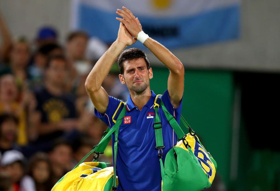 <p>Novak Djokovic of Serbia shows his emotion as he waves to the crowd after his defeat against Juan Martin Del Potro of Argentina in their singles match on Day 2 of the Rio 2016 Olympic Games at the Olympic Tennis Centre on August 7, 2016 in Rio de Janeiro, Brazil. (Photo by Clive Brunskill/Getty Images) </p>