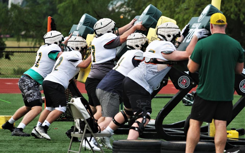 The Rock Bridge offensive line runs through a drill during a summer practice on July 19, 2023, in Columbia, Mo.
