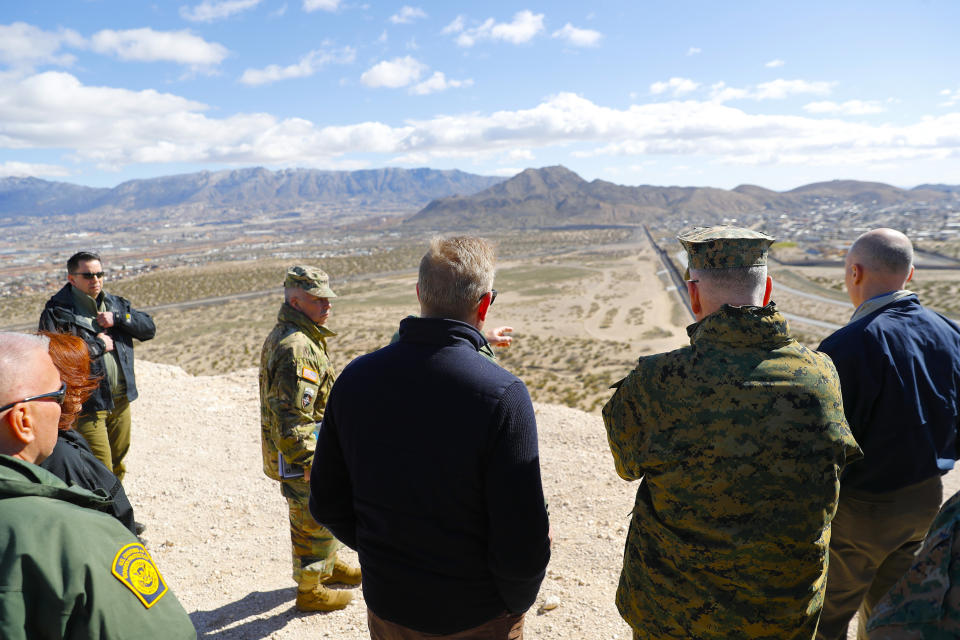 Acting Secretary of Defense Patrick Shanahan, center, and Joint Chiefs Chairman Gen. Joseph Dunford, second from the right, looks across the horizon during a tour of the US-Mexico border at Santa Teresa Station in Sunland Park, N.M., Saturday, Feb. 23, 2019. Top defense officials toured sections of the U.S.-Mexico border Saturday to see how the military could reinforce efforts to block drug smuggling and other illegal activity, as the Pentagon weighs diverting billions of dollars for President Donald Trump's border wall. (AP Photo/Pablo Martinez Monsivais)