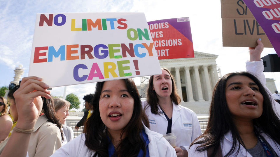 Abortion rights supporters hold placards on the day the Supreme Court justices hear oral arguments over the legality of Idaho's Republican-backed, near-total abortion ban in medical-emergency situations, at the U.S. Supreme Court in Washington, U.S., April 24, 2024. REUTERS/Kevin Lamarque