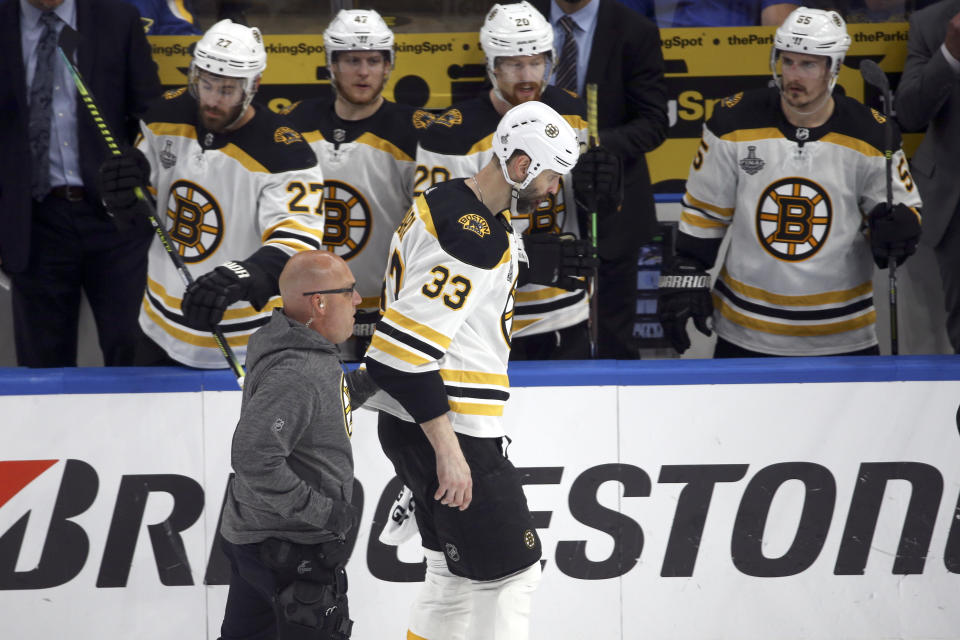 Boston Bruins defenseman Zdeno Chara (33), of Slovakia, leaves the ice after being hit in the face by the puck during the second period of Game 4 of the NHL hockey Stanley Cup Final against the St. Louis Blues Monday, June 3, 2019, in St. Louis. (AP Photo/Scott Kane)