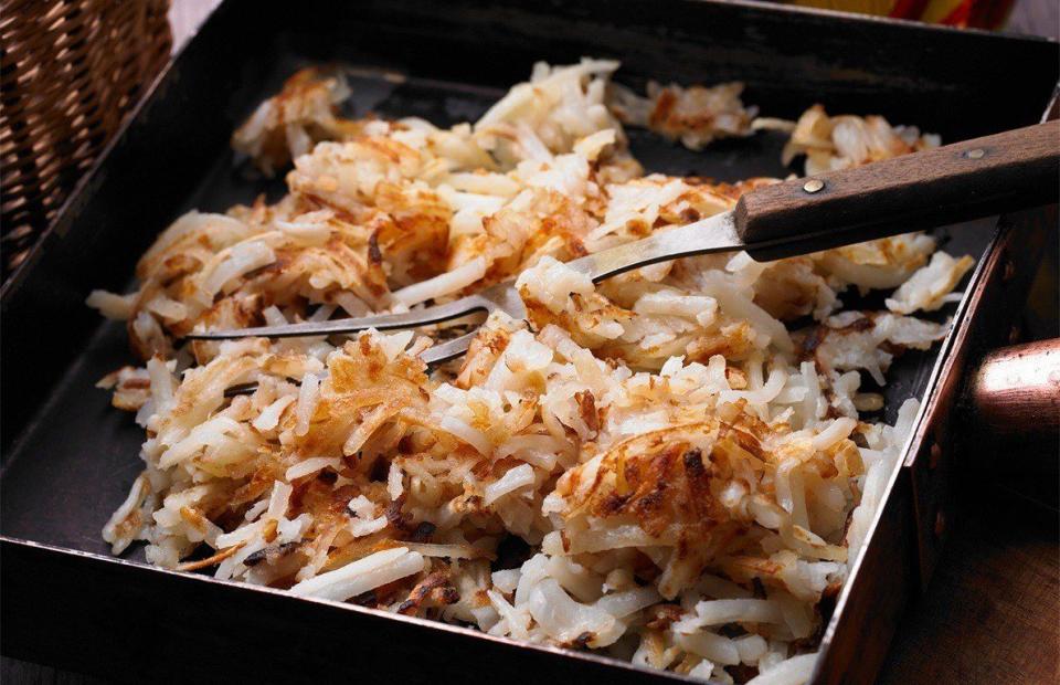 <p>Yes, you heard correctly. These hash browns are cooked in a waffle press to make them extra crispy and delicious. The recipe requires only three main ingredients: grated russet potatoes, shredded Parmesan cheese, and one large egg. Top them with a fried or poached egg for the ultimate brunch entrée.</p><p><a href="https://www.thedailymeal.com/recipes/herbed-parmesan-hash-browns-recipe" rel="nofollow noopener" target="_blank" data-ylk="slk:Click here for the Herbed Parmesan Hash Browns recipe.;elm:context_link;itc:0;sec:content-canvas" class="link "><b>Click here for the Herbed Parmesan Hash Browns recipe.</b></a> </p>