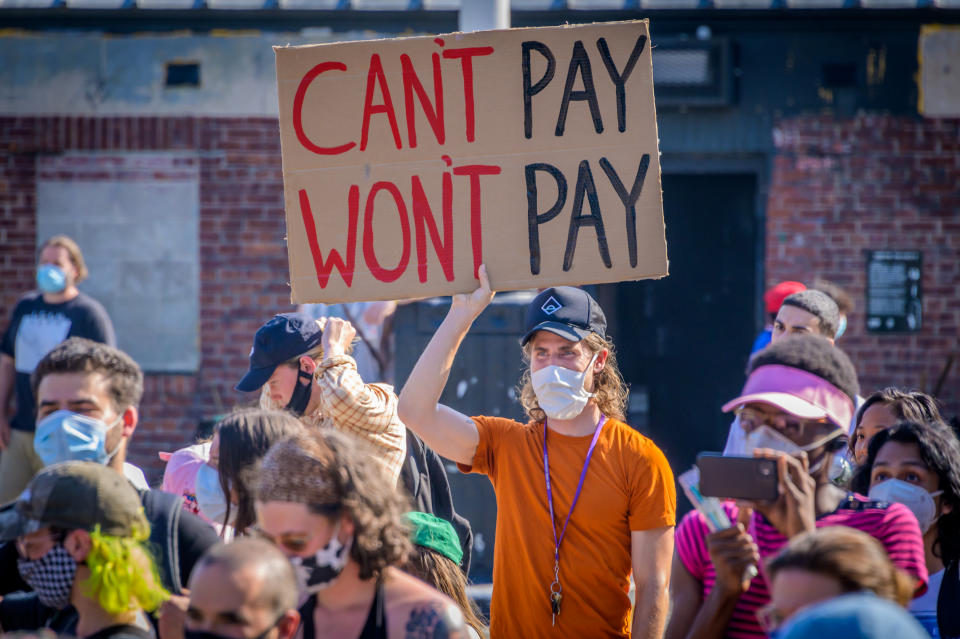 BROOKLYN, NEW YORK, UNITED STATES - 2020/07/05: A participant holding a Can't Pay Won't Pay sign at the protest. Tenants and Housing Activists gathered at Maria Hernandez Park for a rally and march in the streets of Bushwick, demanding the city administration to cancel rent immediately as the financial situation for many New Yorkers remains the same, strapped for cash and out of work. (Photo by Erik McGregor/LightRocket via Getty Images)