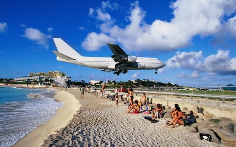 Saint-Martin airport is famous as its runway ends very close to a beach - Credit: Angelo Cavalli/Getty