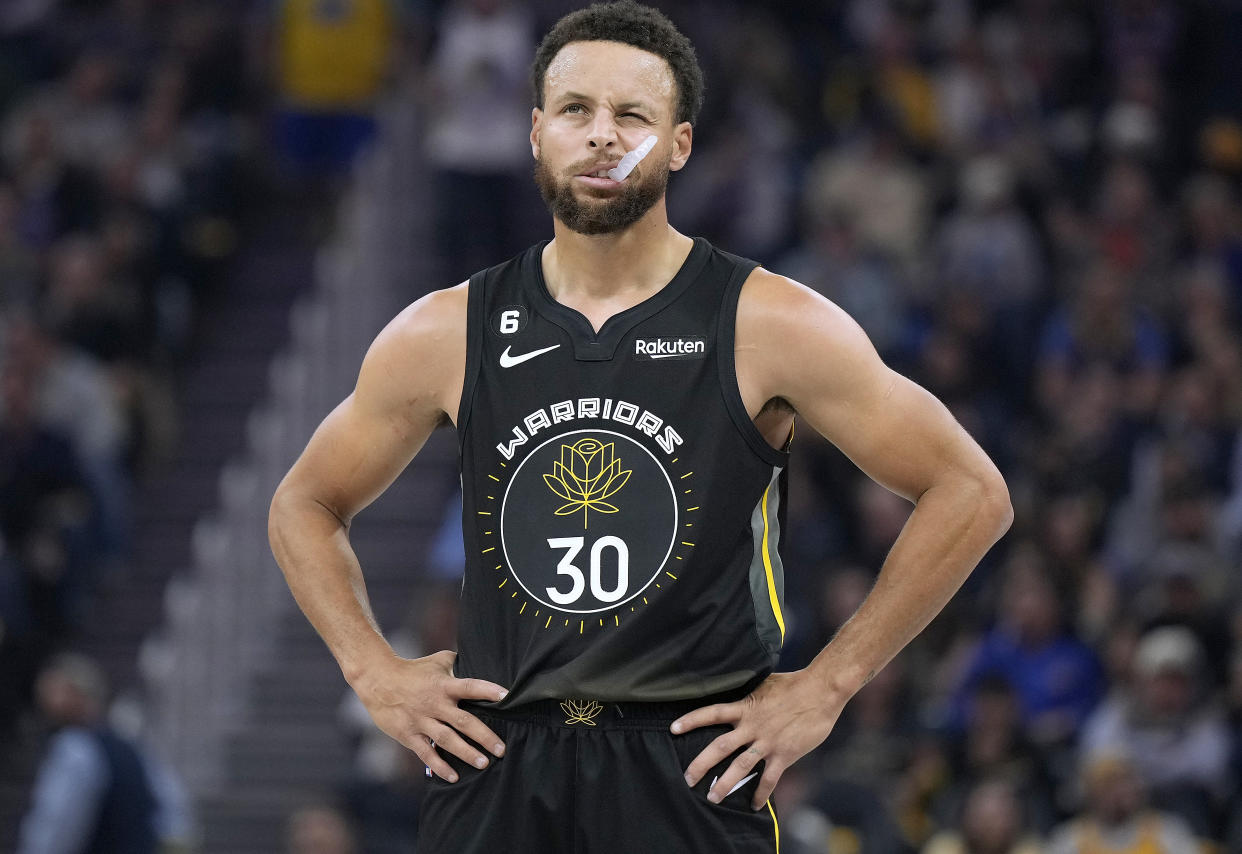 Stephen Curry of the Golden State Warriors looks on against the New York Knicks during the first quarter of an NBA basketball game at Chase Center on November 18, 2022 in San Francisco, California. 