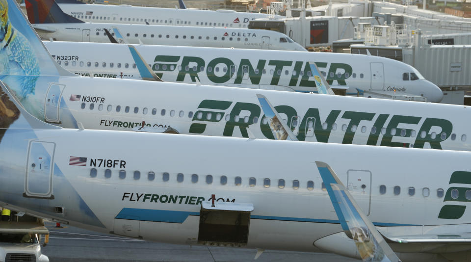 In this late Wednesday, June 26, 2019, photograph, Frontier Airlines jetliners sit at gates on the A concourse at Denver International Airport in Denver. (AP Photo/David Zalubowski)